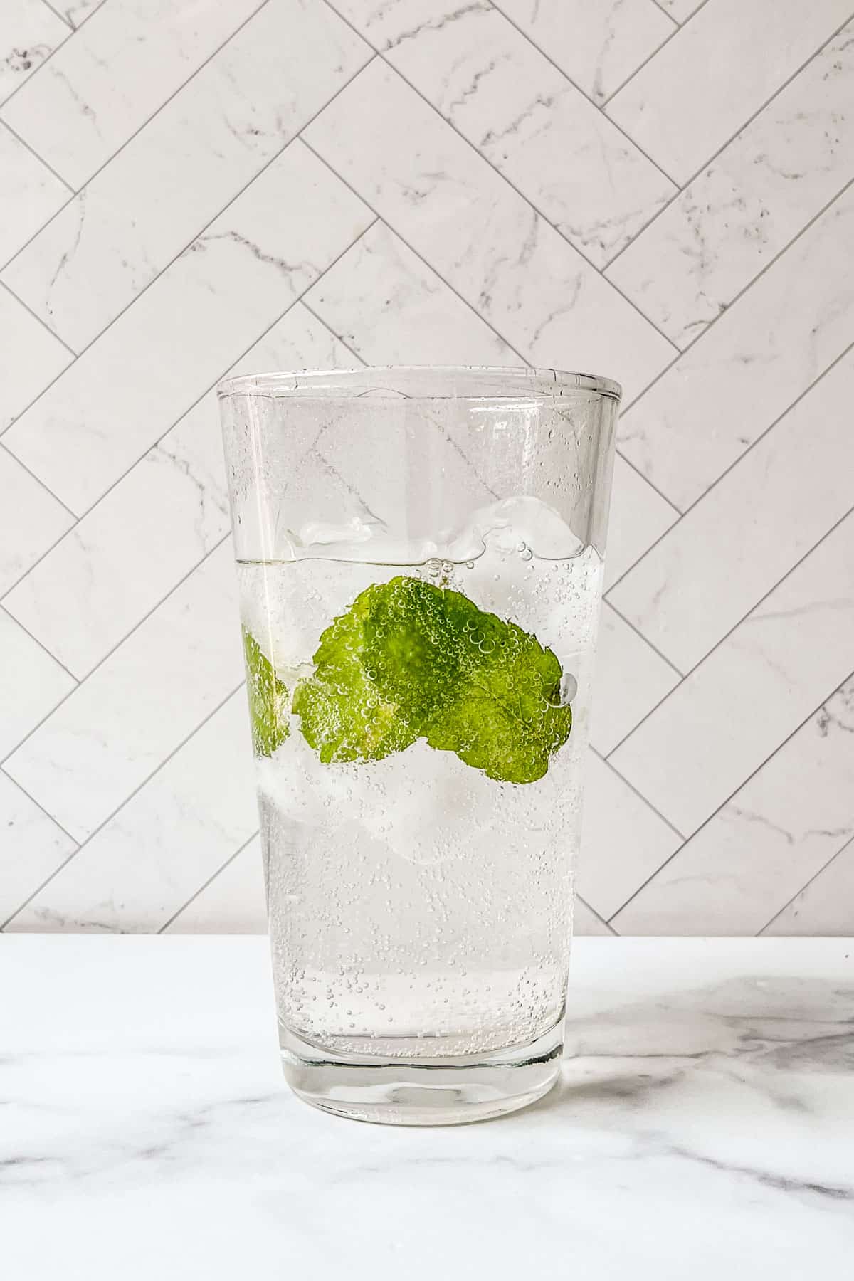 Mint, ice, and tonic water in a glass.