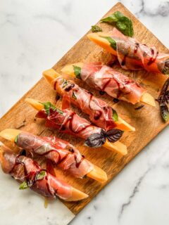 Prosciutto and melon on an appetizer board.