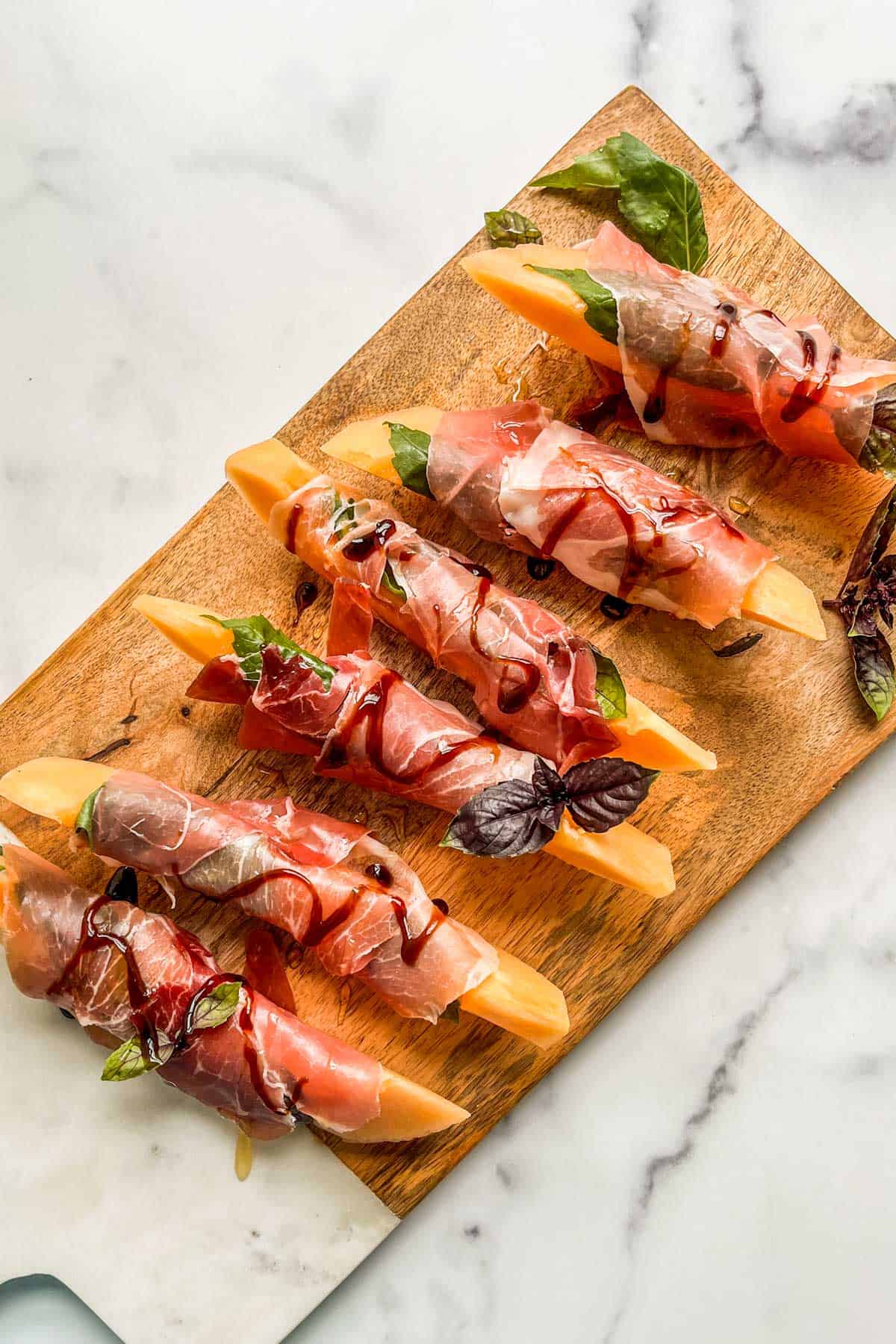 Prosciutto and melon on an appetizer board.