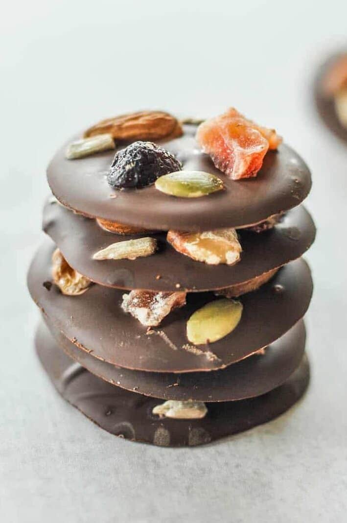 fruit and nut dark chocolate bites stacked on top of each other