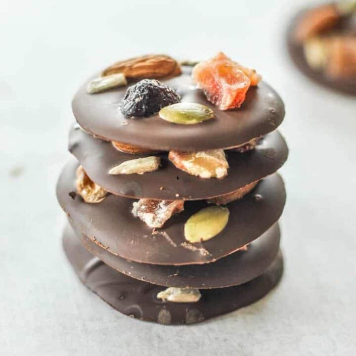 Fruit and nut dark chocolate bites in a stack.