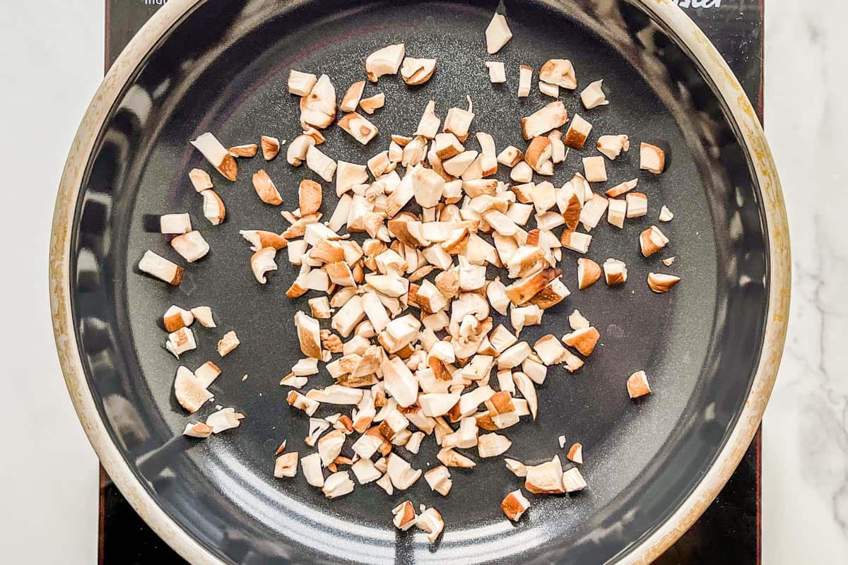 Chopped mushrooms in a frying pan.