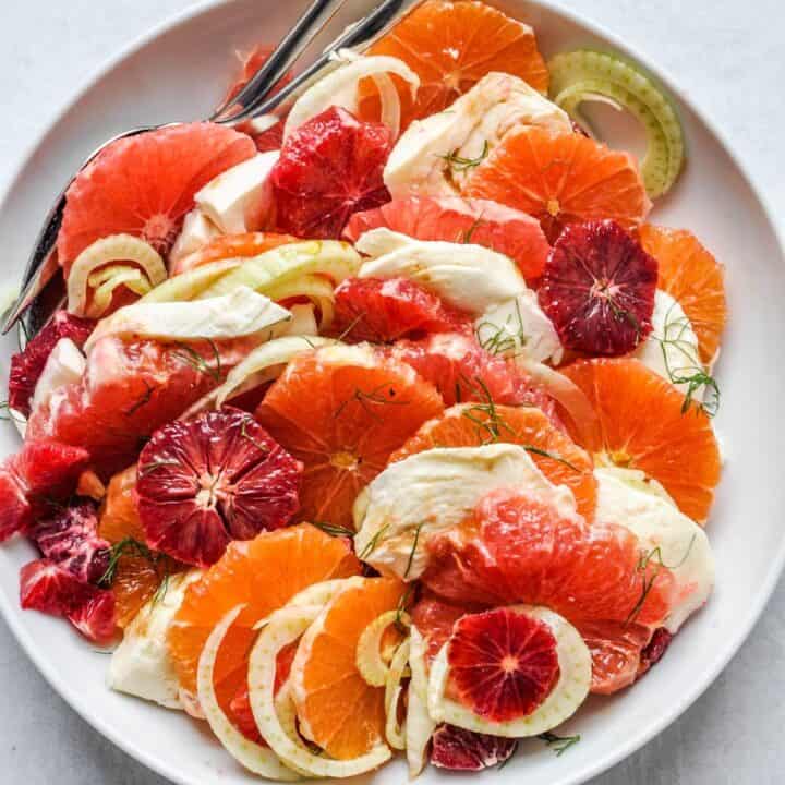 Orange fennel salad recipe in a white bowl.