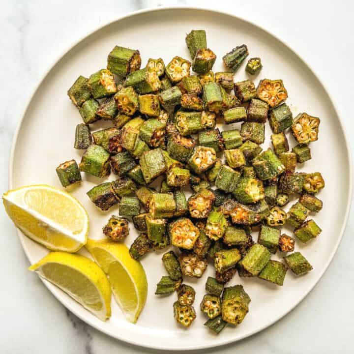 Oven roasted okra on a white plate.