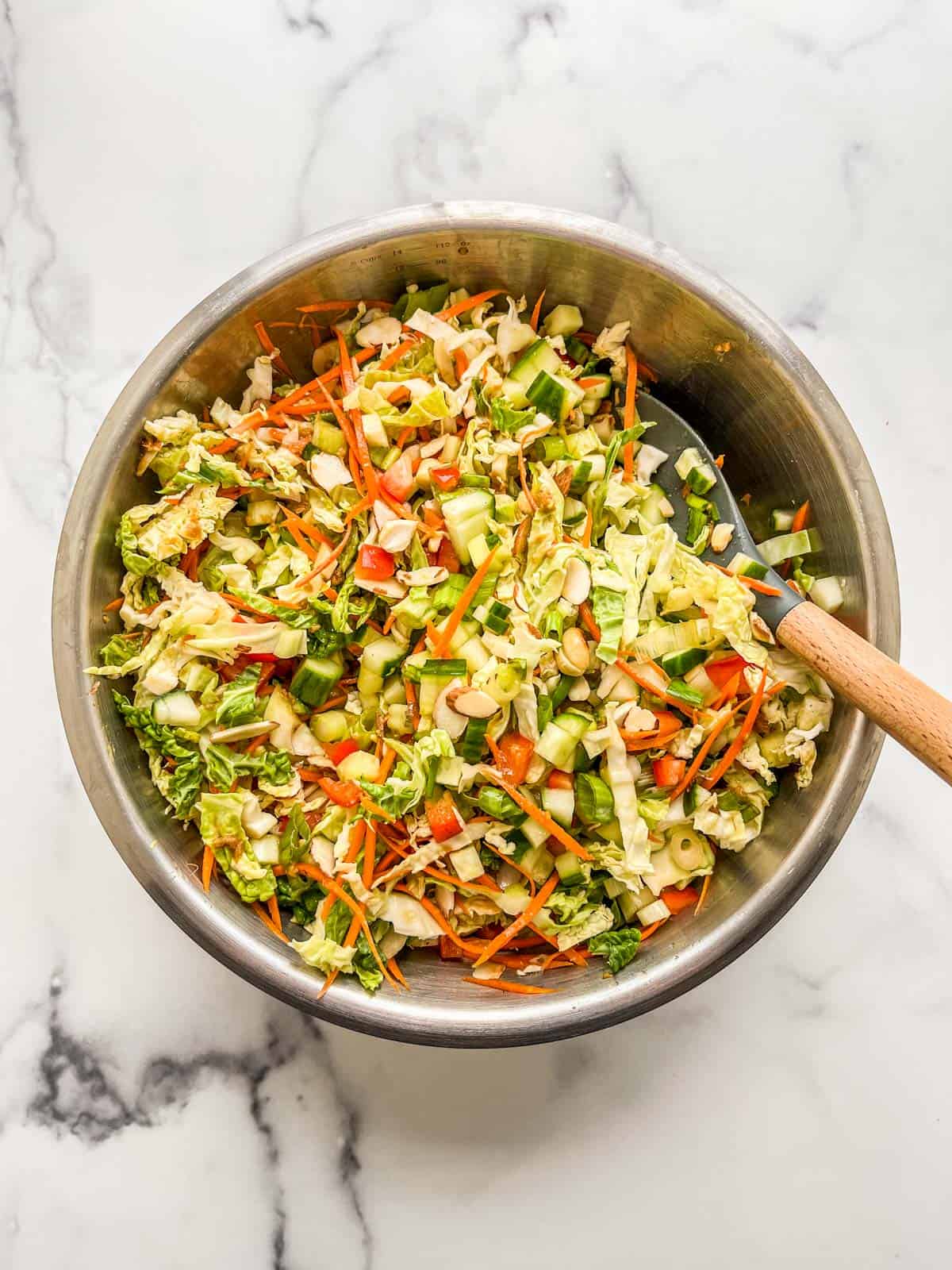 A savoy cabbage salad in a metal bowl.