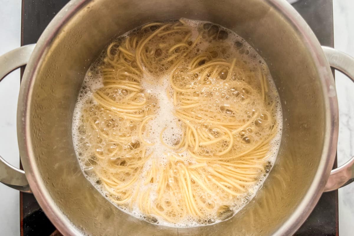 Cooking ramen noodles in a pot.