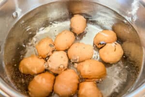 Eggs in a pot of boiling water.