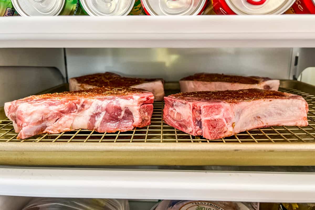 Pork chops dry brining in the refrigerator.