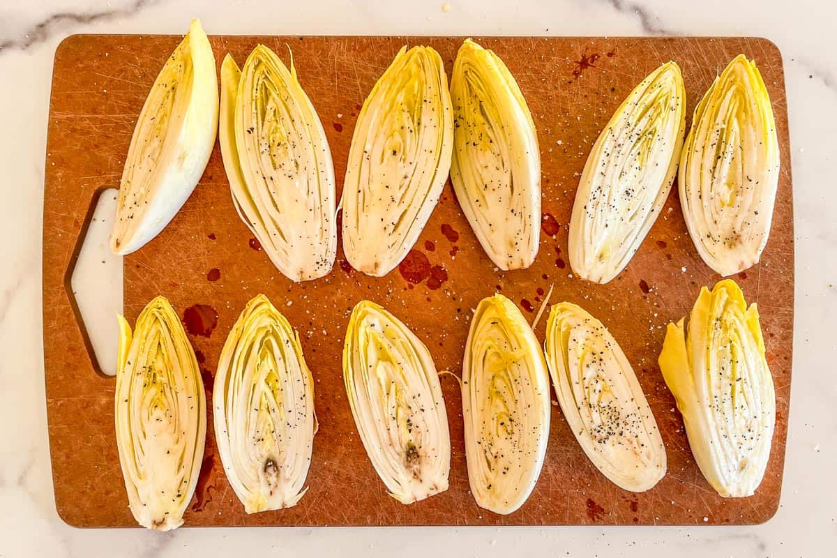 Sliced endives brushed with olive oil and topped with salt and pepper.