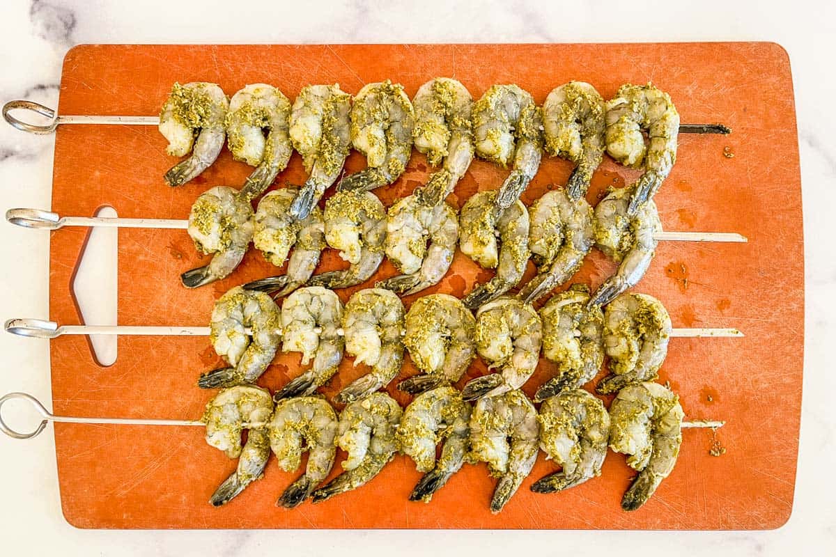 Shrimp skewers on a cutting board.