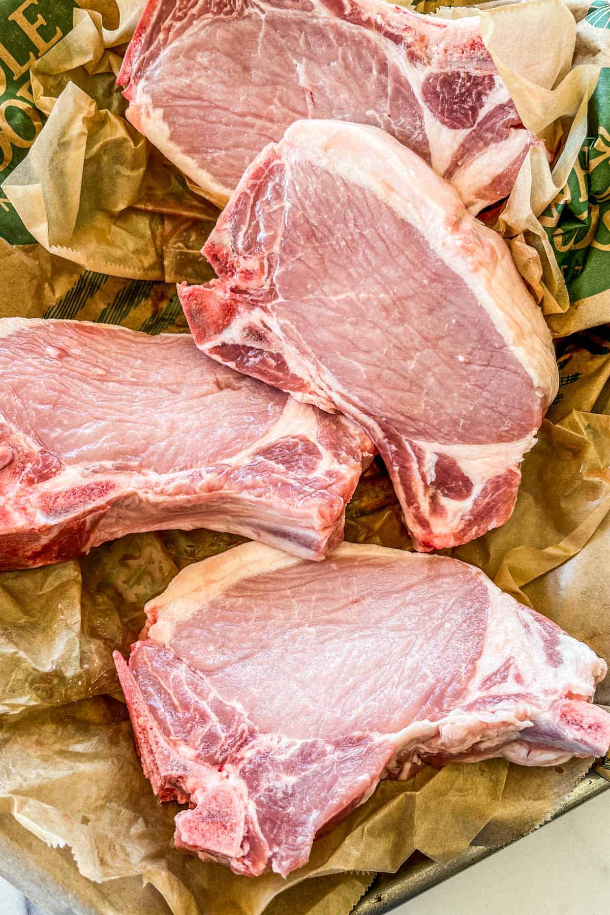 Four fresh thick-cut pork chops.