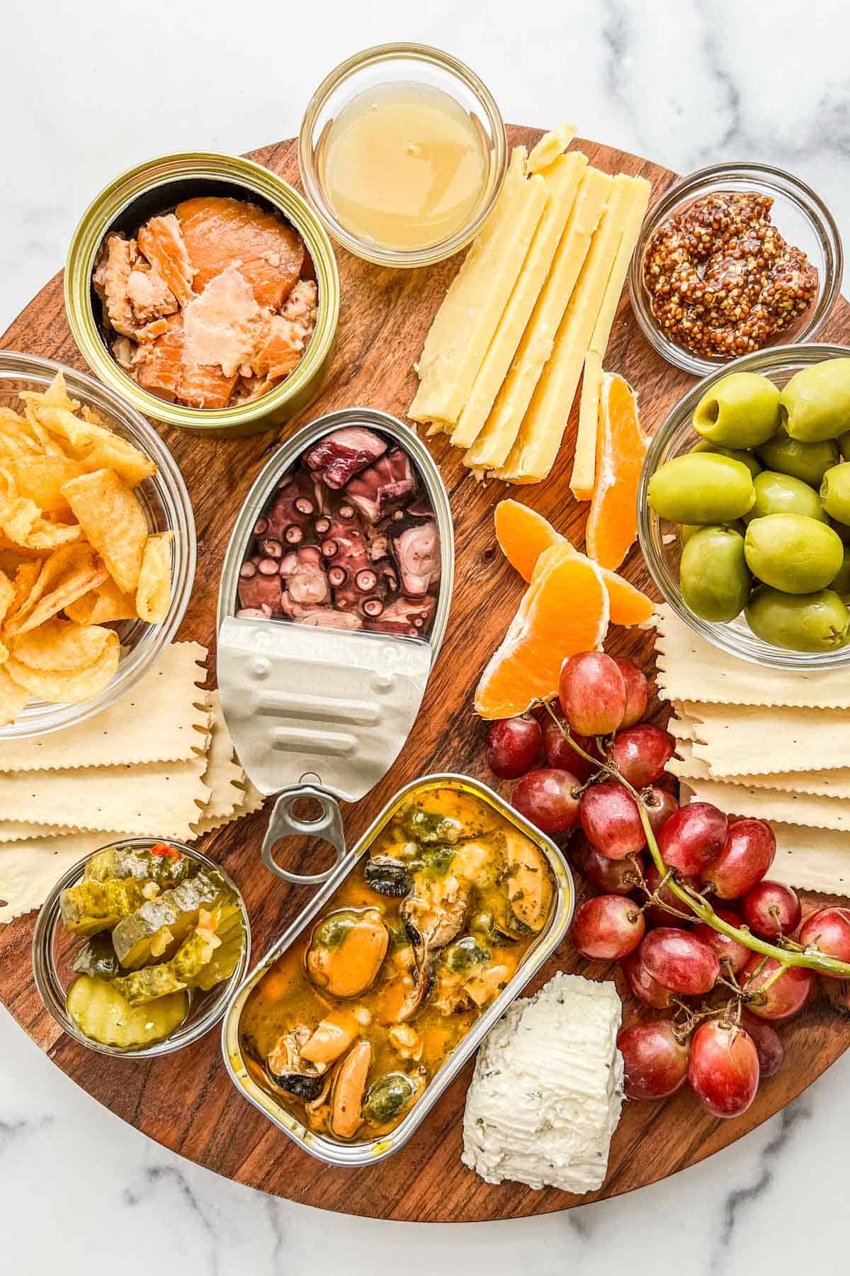 A closeup shot of a tinned fish appetizer board.