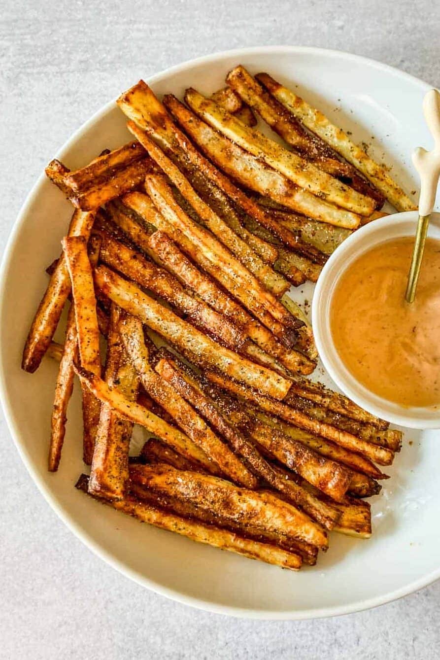 Togarashi fries in a white bowl with a side of spicy mayo.