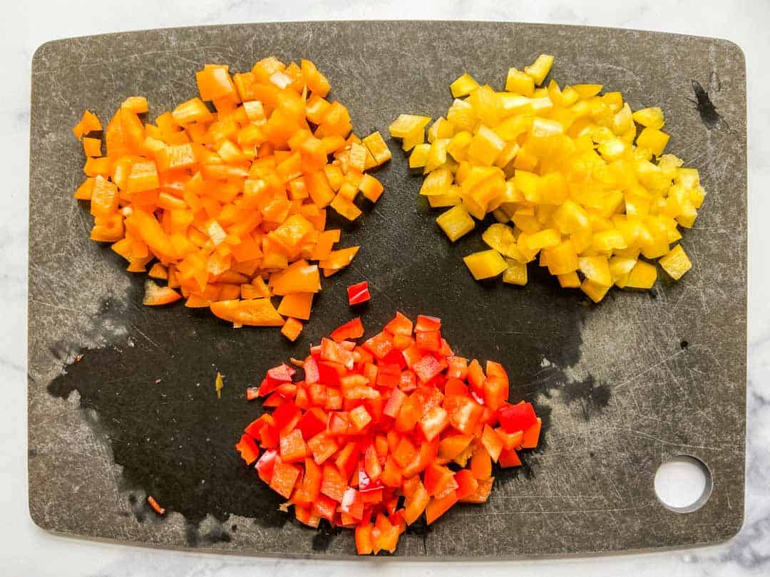 Chopped yellow, orange, and red bell pepper.