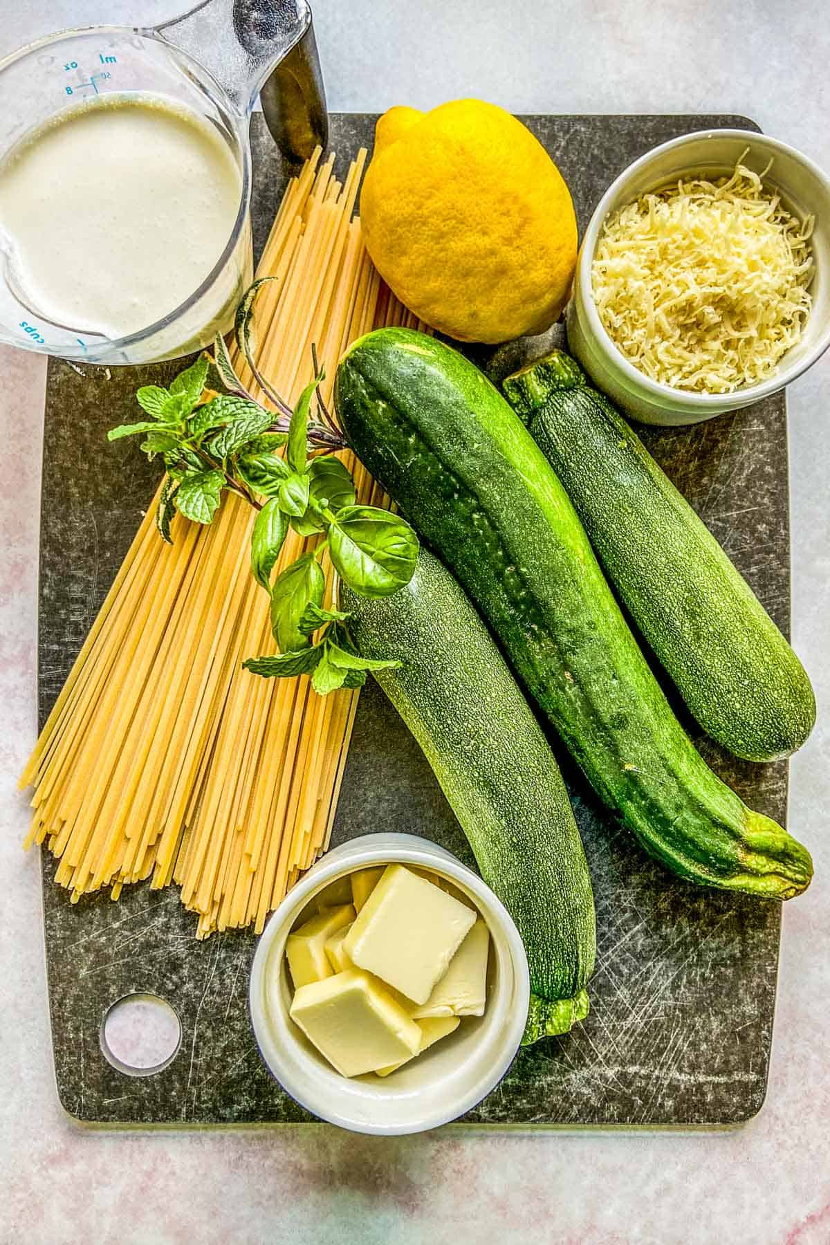Ingredients for a creamy zucchini pasta.