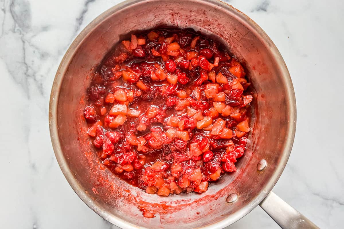 Cooking cranberry apple relish in a pot.