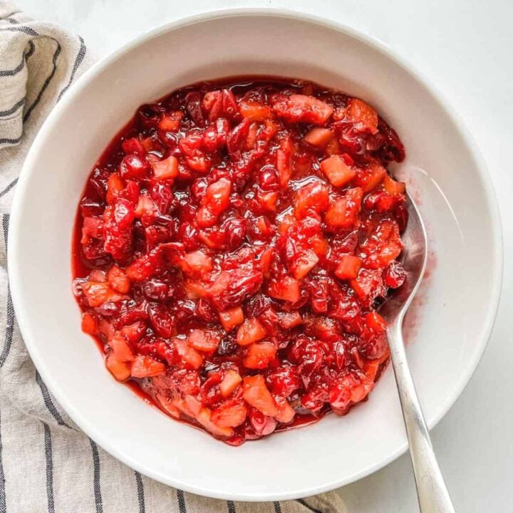 Cranberry apple relish in a white serving bowl.