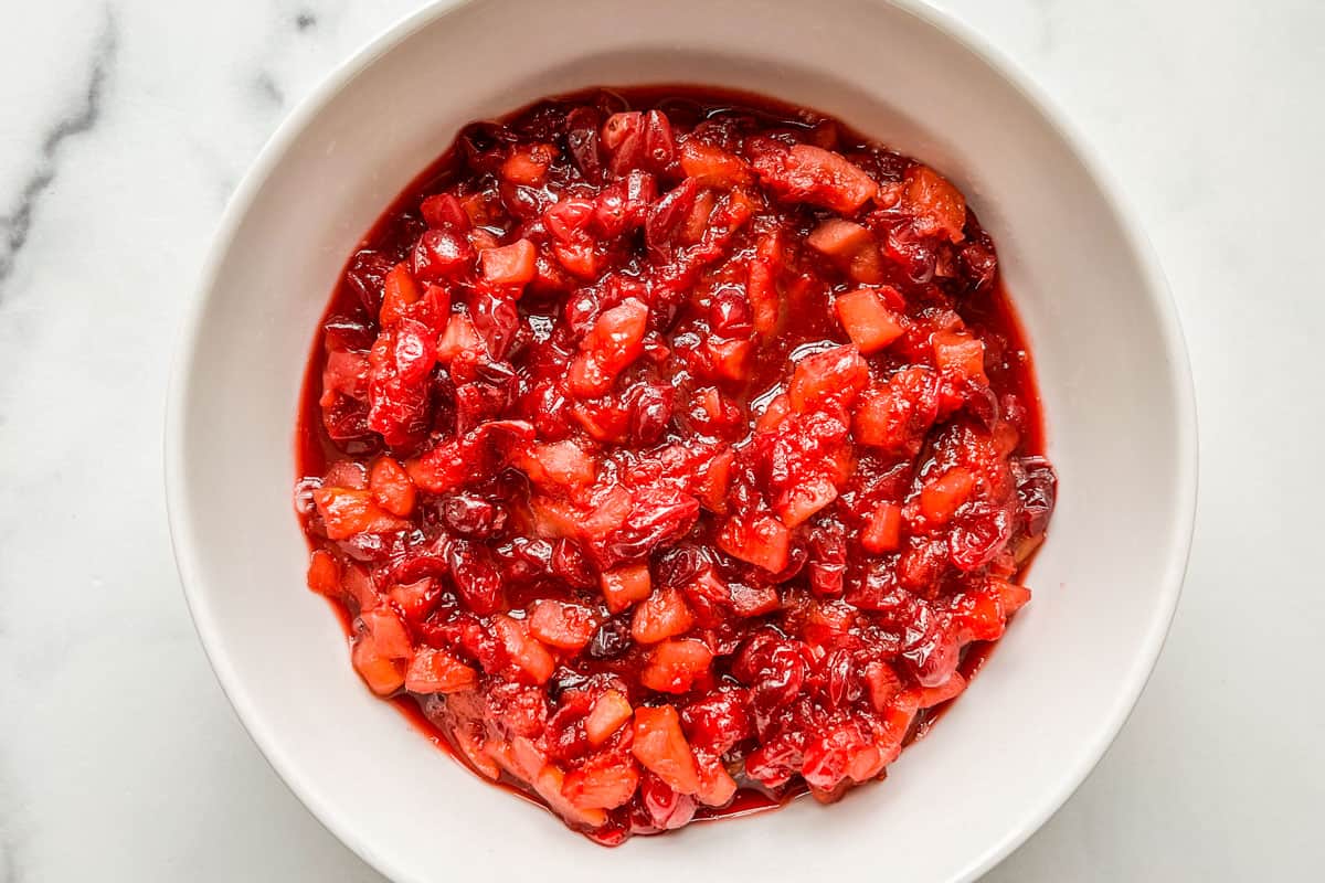 Cranberry relish with apples and ginger in a serving bowl.