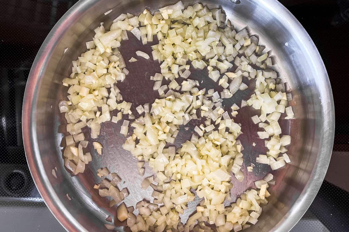 Chopped onions and garlic in a frying pan.