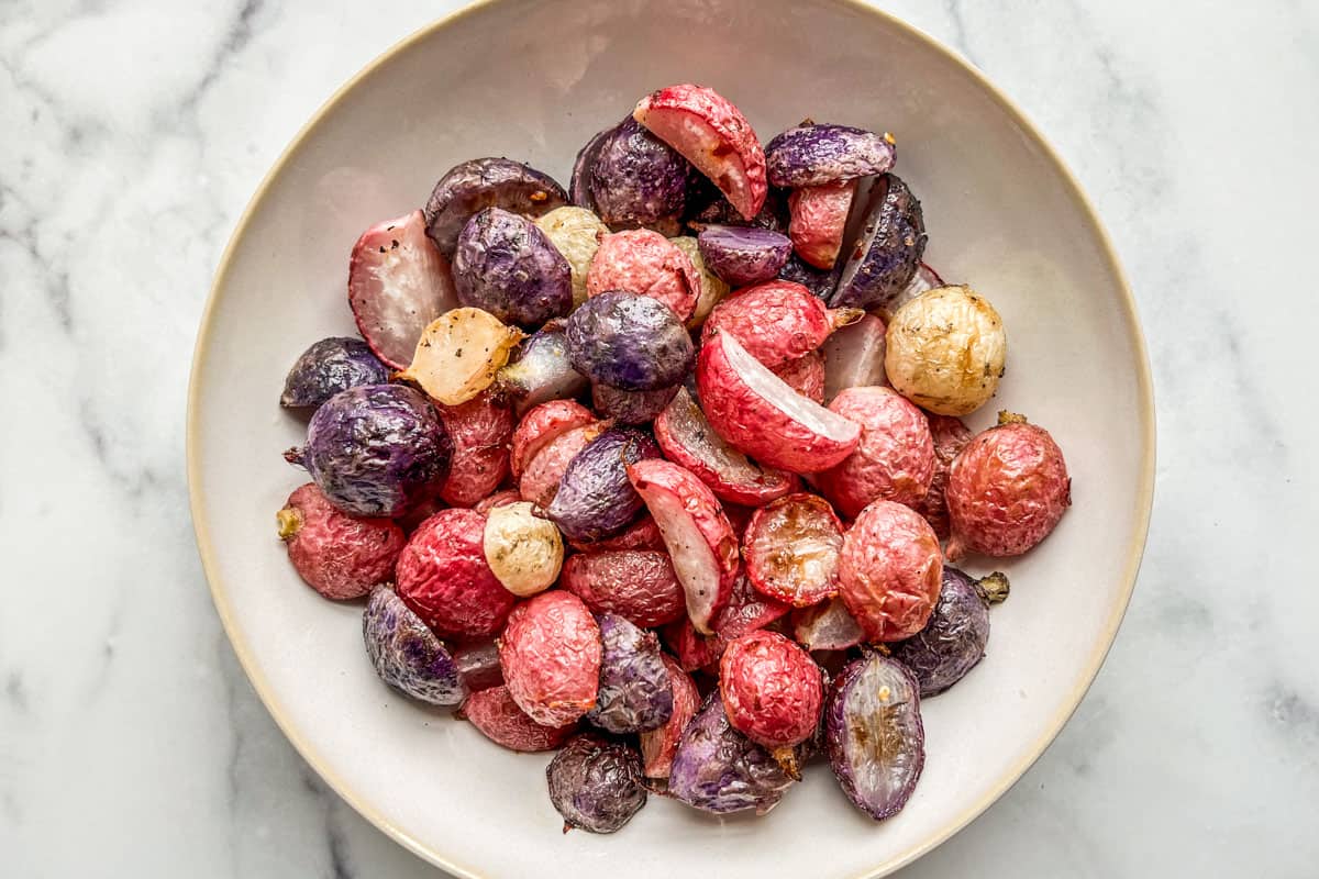 Roasted radishes in a serving bowl.