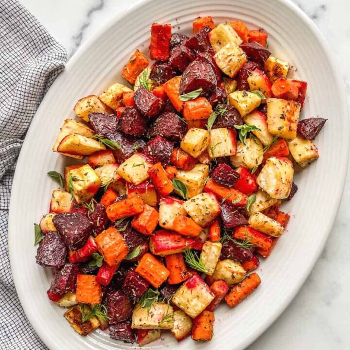 Oven roasted root vegetables on a white serving platter.