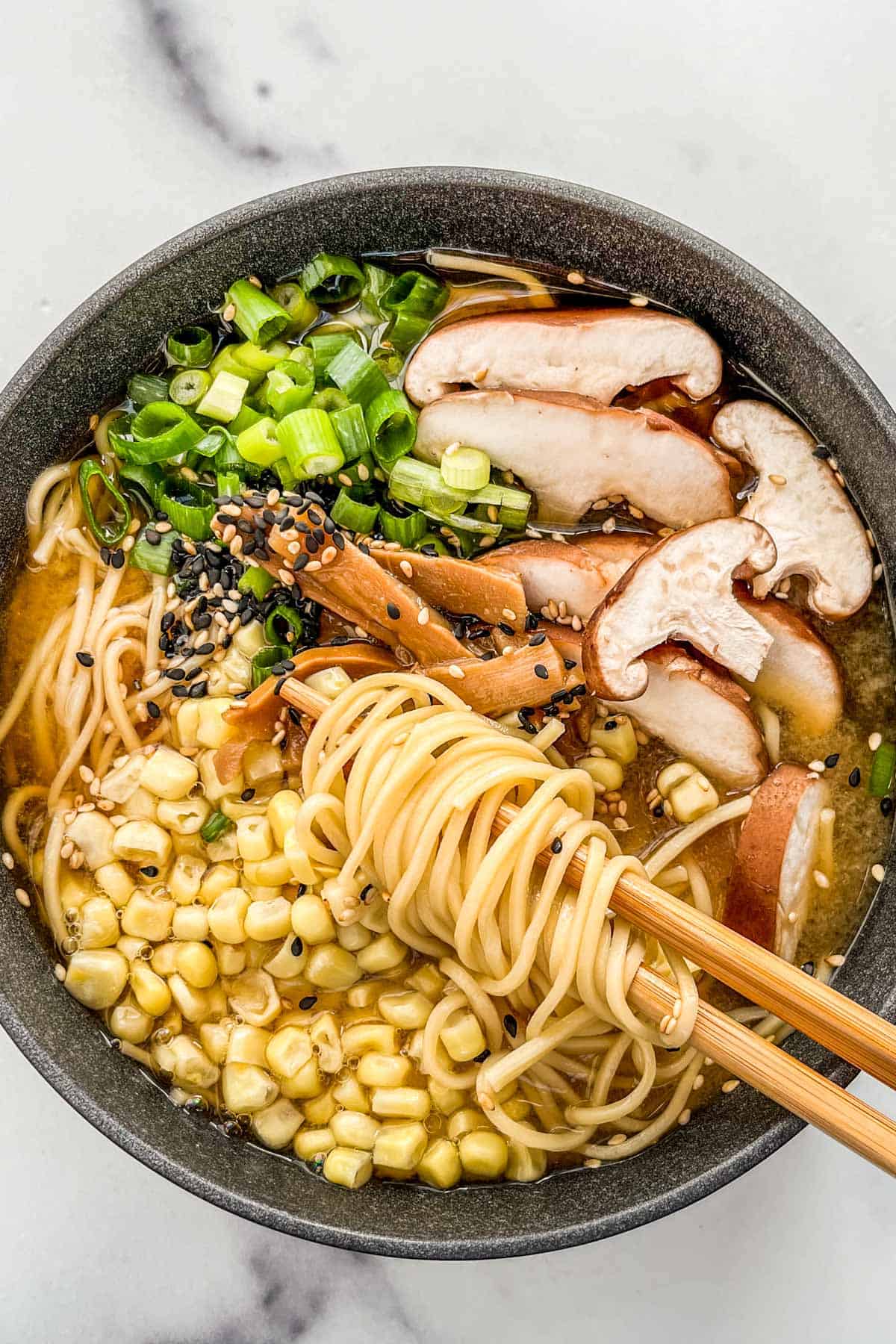 Vegetarian miso ramen in a black bowl.