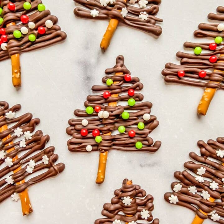 Dark chocolate Christmas trees on a marble background.