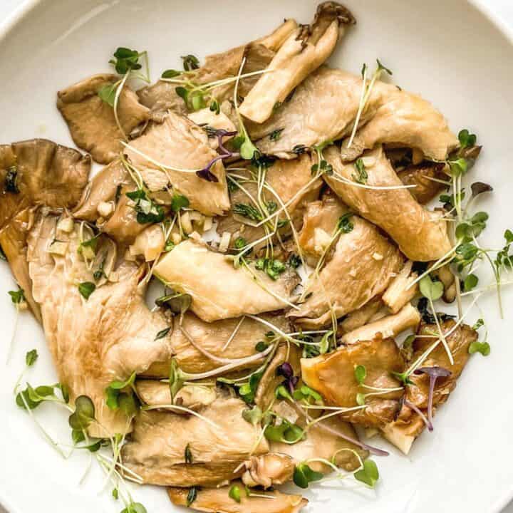 Pan-fried oyster mushrooms in a white bowl.