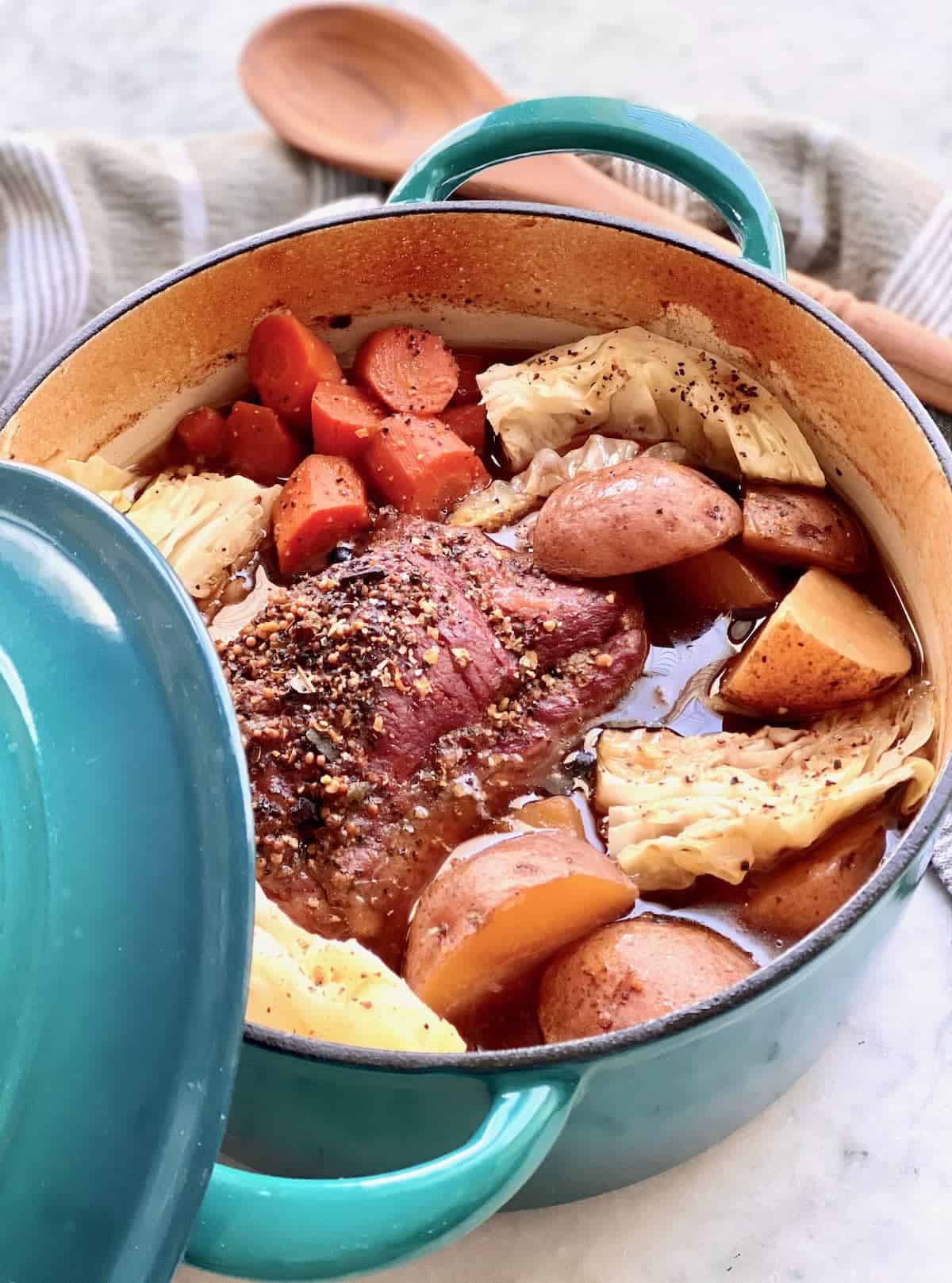 Dutch oven corned beef with potatoes and carrots.