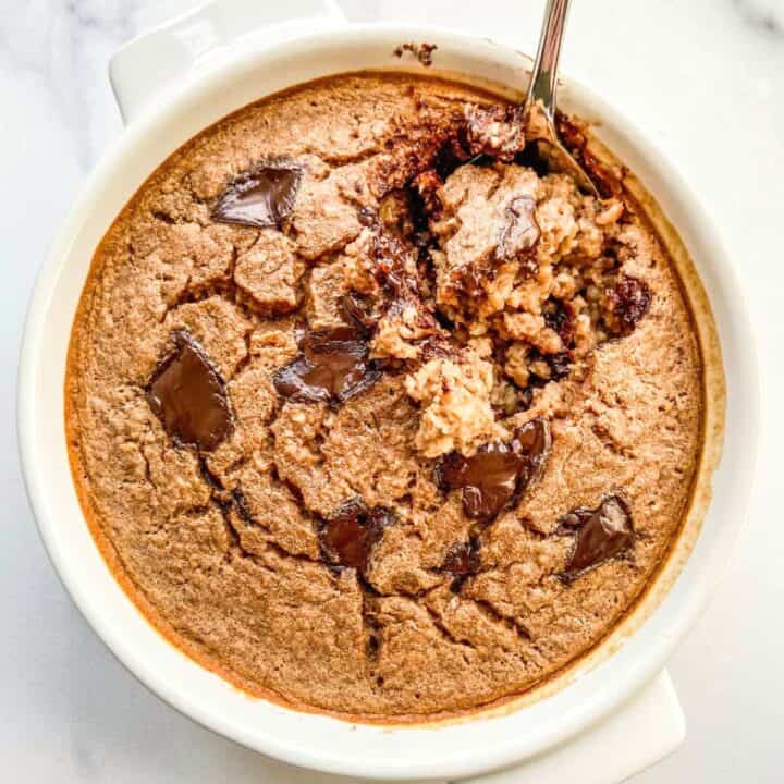 Chocolate baked oats in a white ramekin.