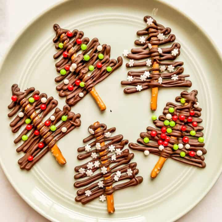 Dark chocolate trees for Christmas on a green plate.