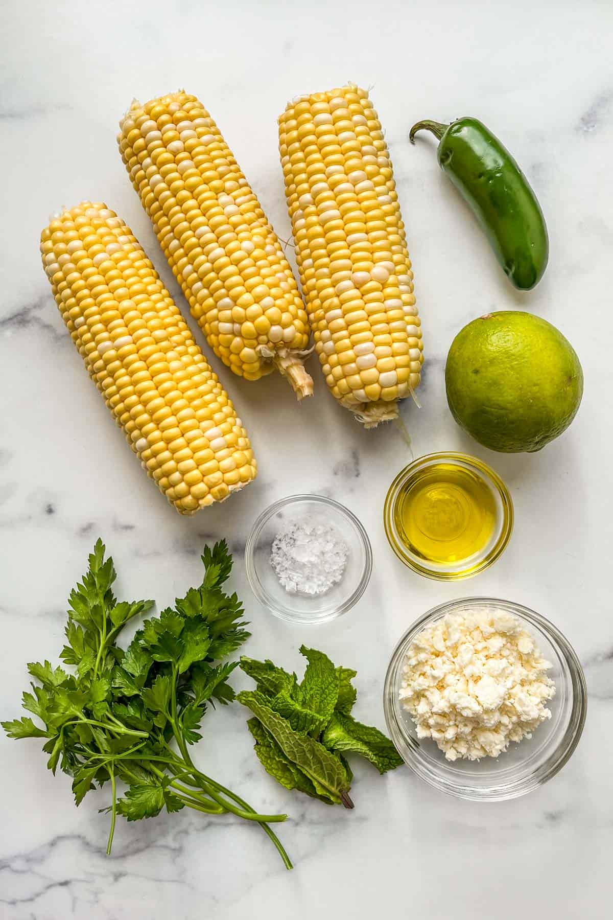 Sweet corn, jalapeno, lime, olive oil, feta cheese, mint, and parsley.