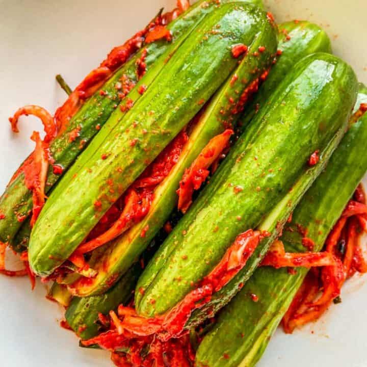 Cucumber kimchi in a white bowl.