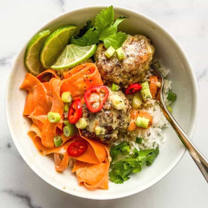 A bowl of healthy ground beef meatballs and veggies.