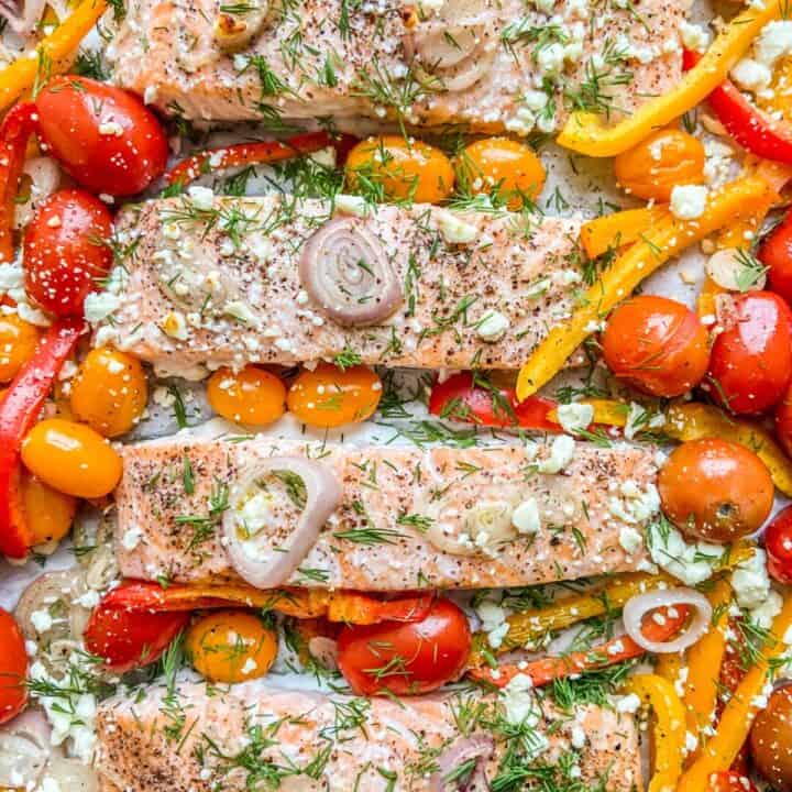 Sheet pan Mediterranean salmon with bell peppers and tomatoes.