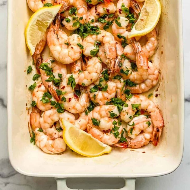 Oven baked shrimp in a baking dish.
