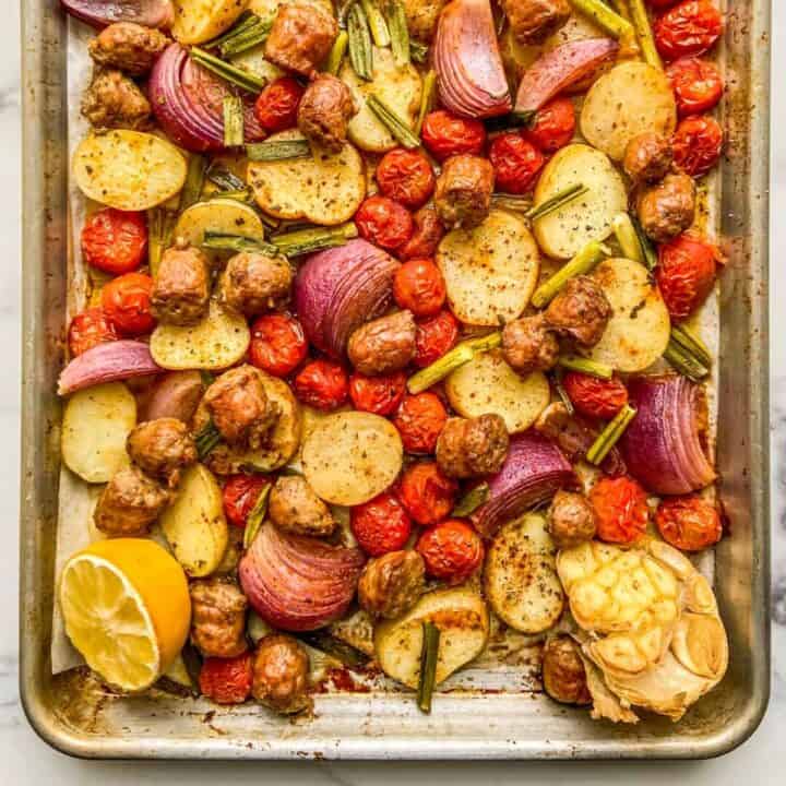 Sheet pan sausage, potatoes and tomatoes.