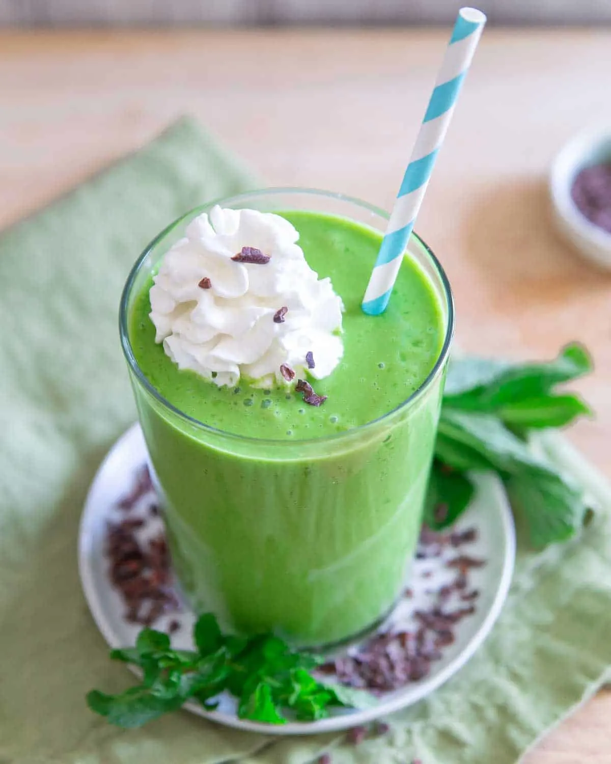 A healthy shamrock shake in a glass with whipped cream.