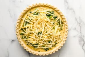 Vegetables quiche mixture in a pie crust.