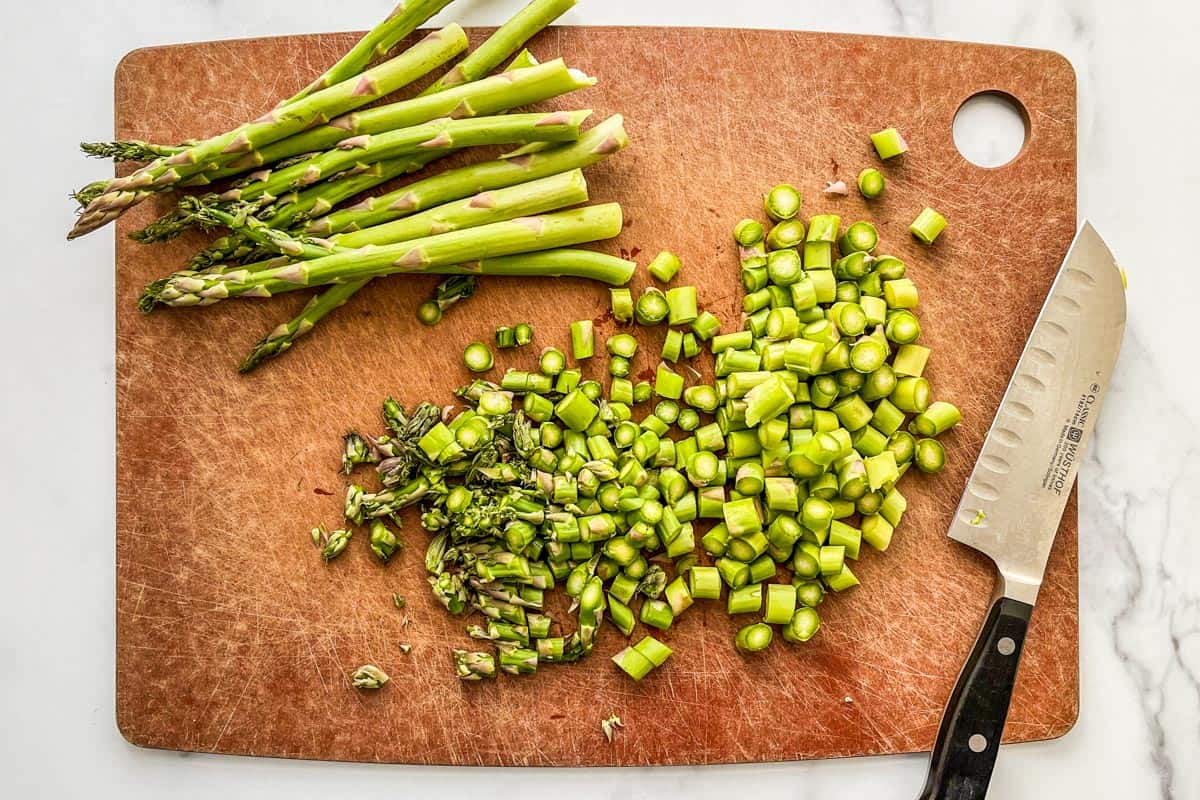 Sliced asparagus on a cutting board.