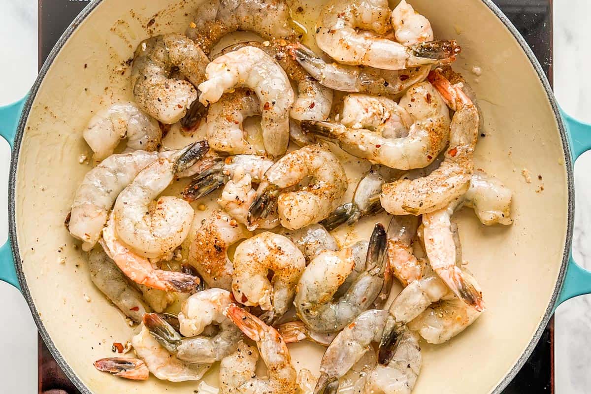 Shrimp with spices being cooked in a skillet.