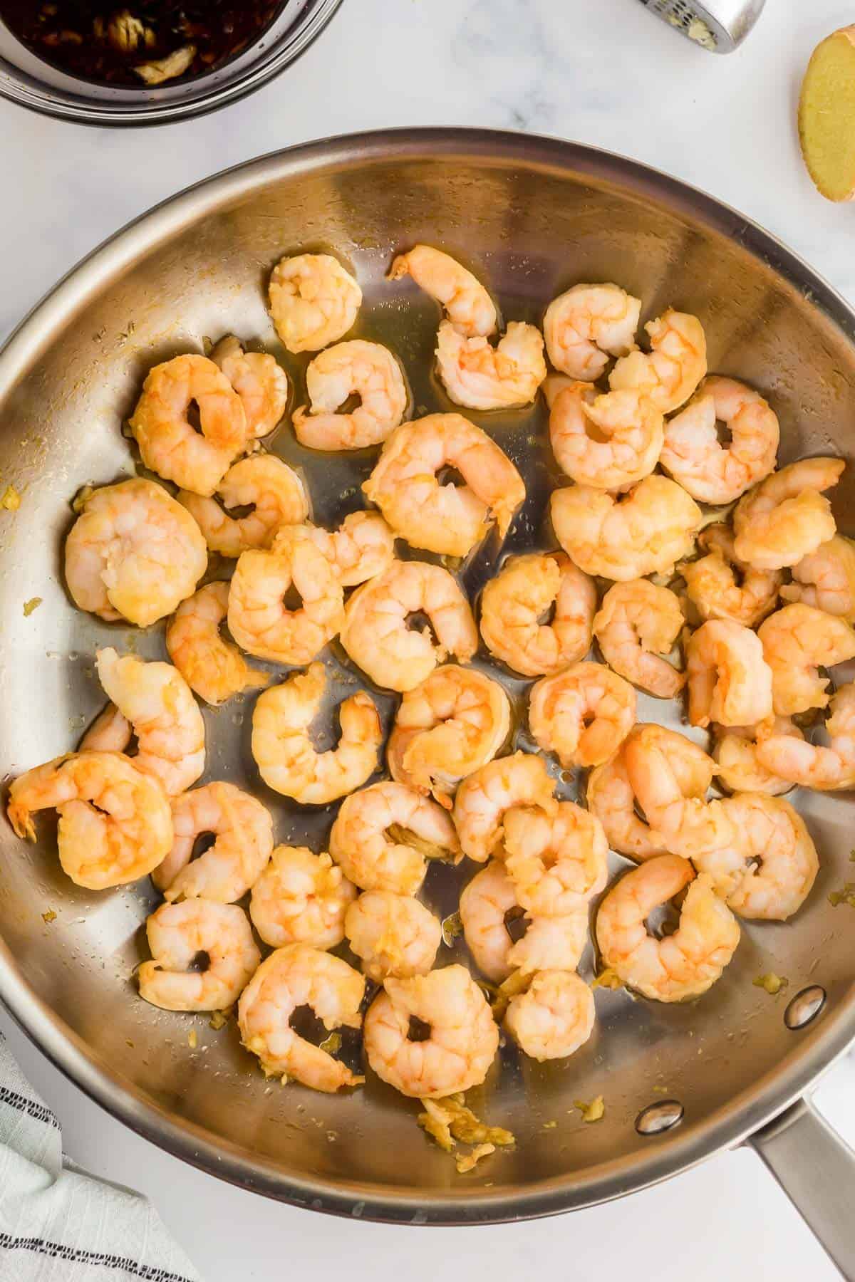 Shrimp being cooked in a frying pan.