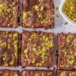 Flourless brownies topped with pistachios.