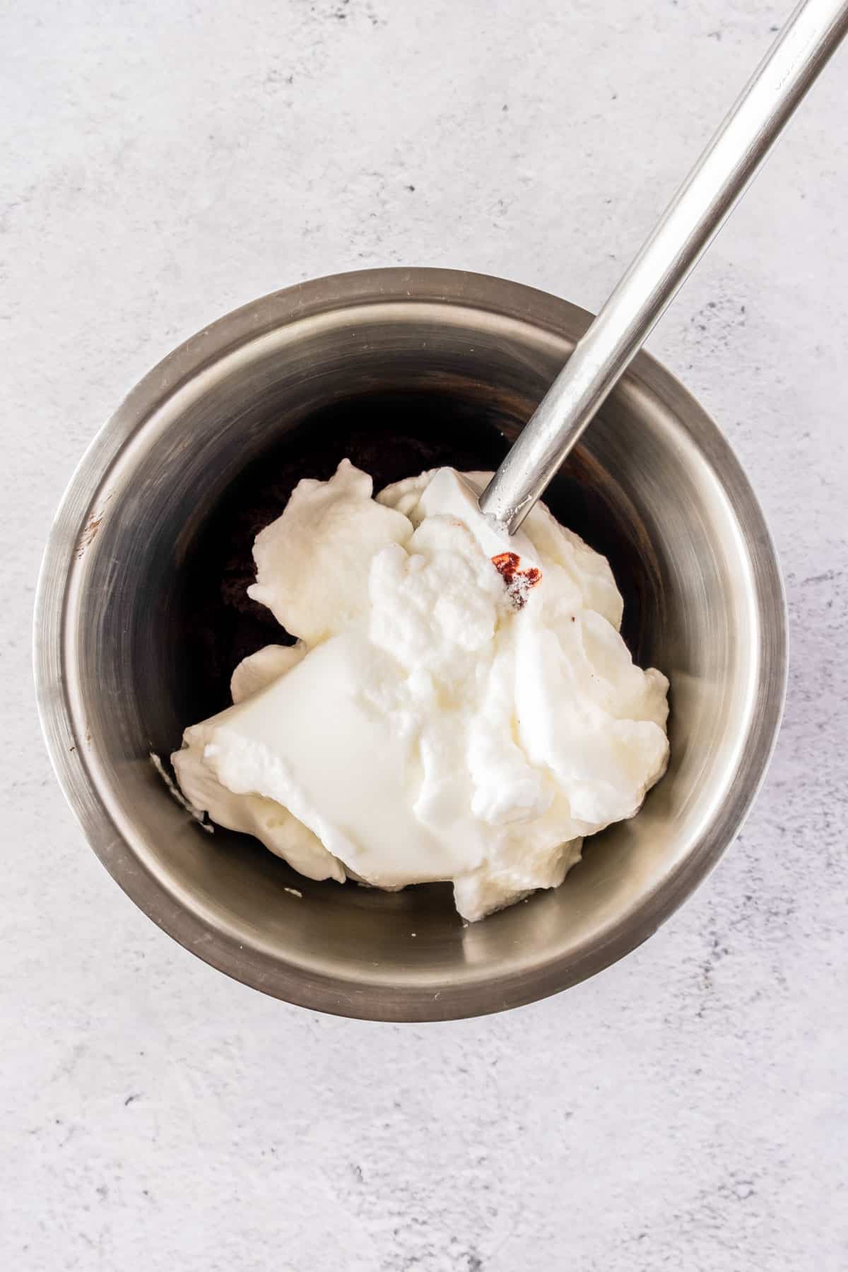 Whipped egg whites in a mixing bowl.