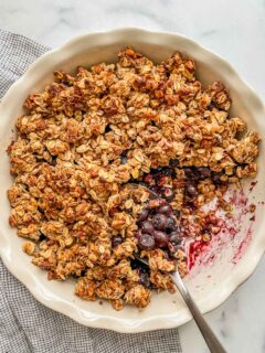 A healthy blueberry crisp recipe in a pie plate.