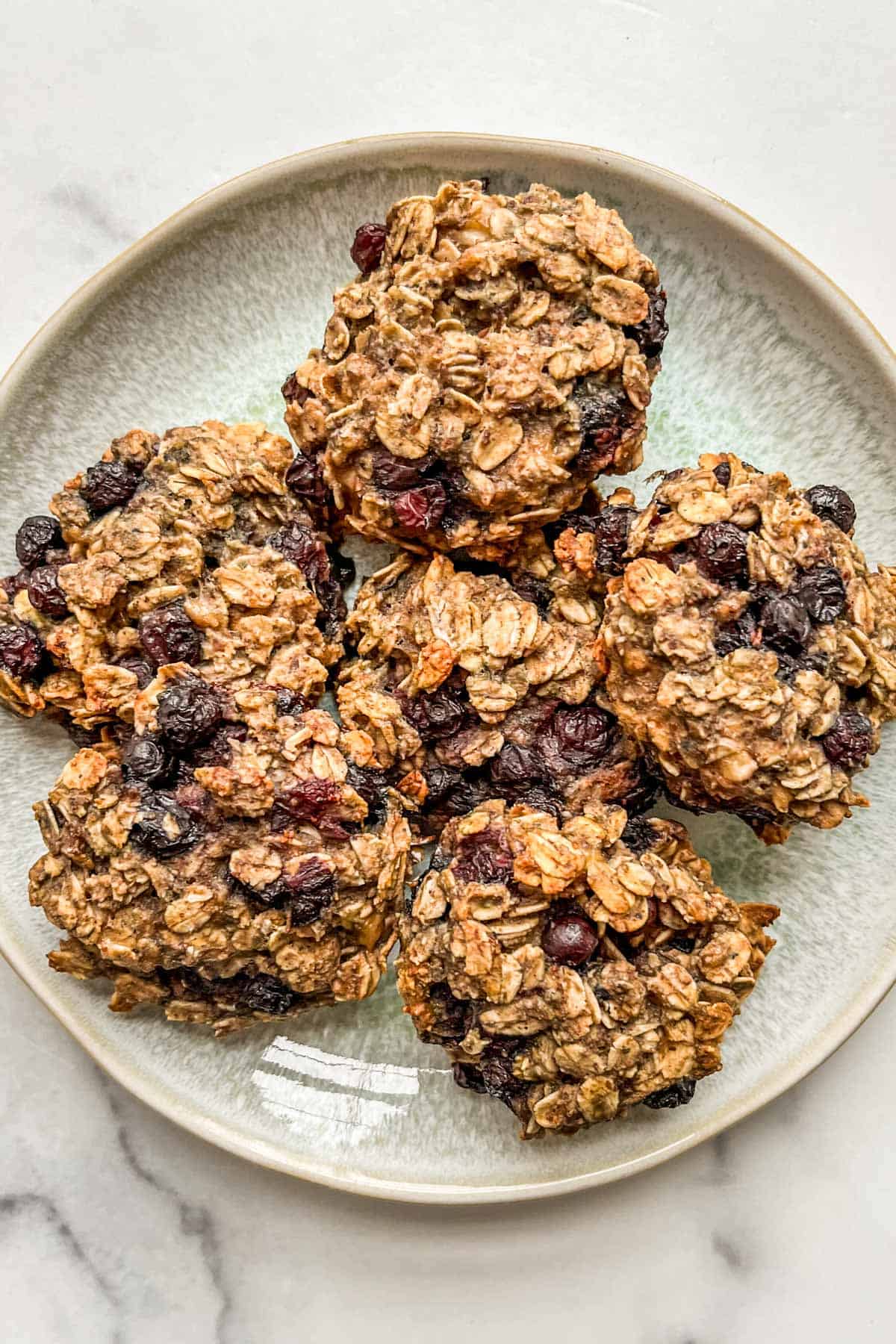 Blueberry breakfast cookies on a small green plate.