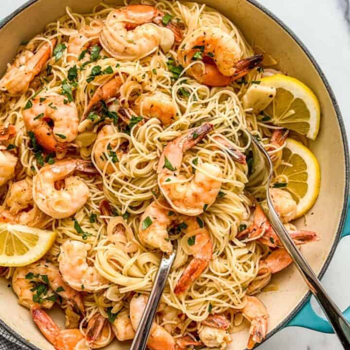 Shrimp seafood pasta with lemon and white wine in a large skillet.