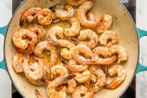 Shrimp being cooked in a skillet.