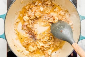A garlic butter and shallot sauce being cooked in a skillet.