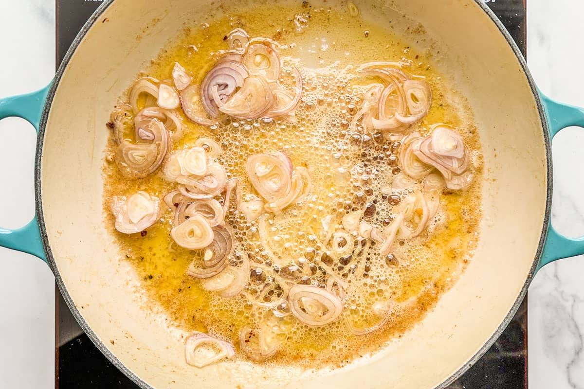 White wine simmering with shallots, garlic, and butter.